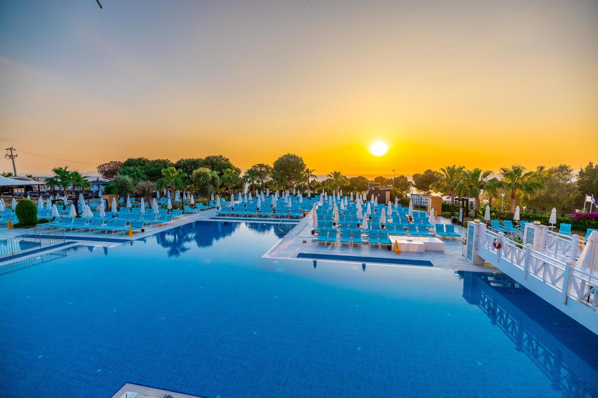 ラマダ リゾート クシャダス＆ゴルフ エクステリア 写真 Sunset at the pool of the hotel